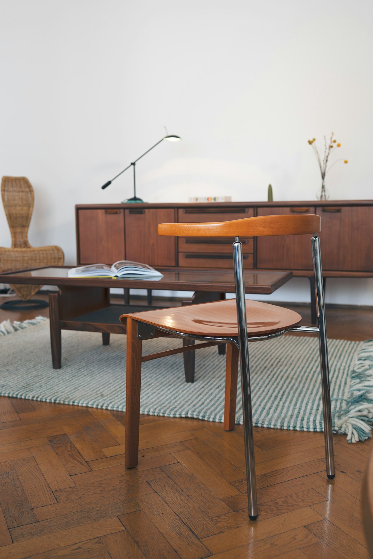 Mid-century modern living space with wooden table and chairs highlighting veneer and proportions