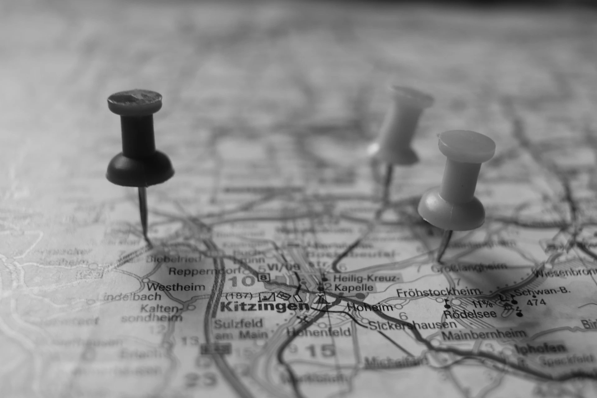 a map with pins on it and a map in the background