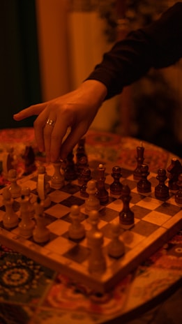 a person playing a game of chess on a table