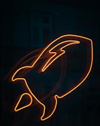a close up of a neon sign in the dark