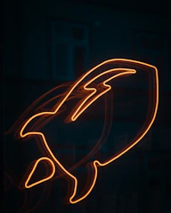 a close up of a neon sign in the dark