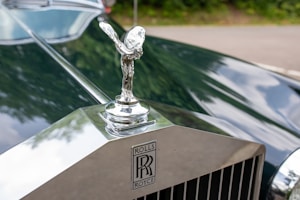 the hood ornament on the front of a classic car