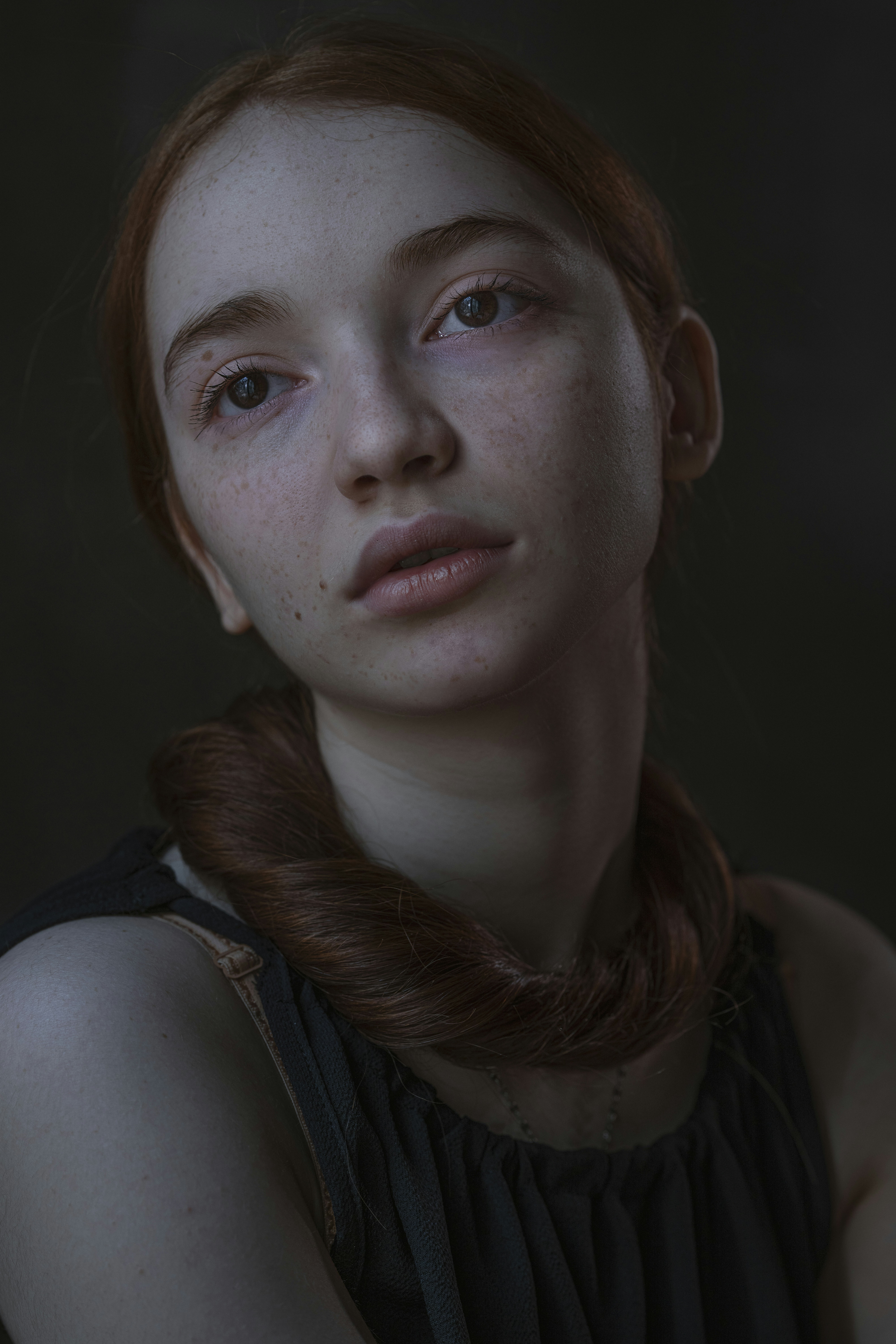 a woman with freckled hair is staring at the camera