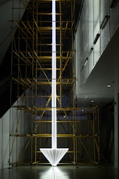 a tall white object with scaffolding around it