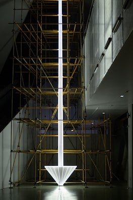 a tall white object with scaffolding around it