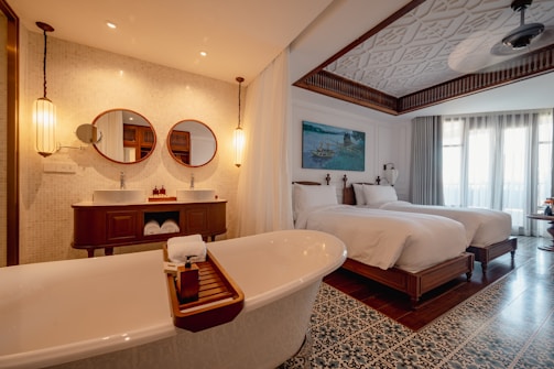a bathroom with two beds and a bathtub