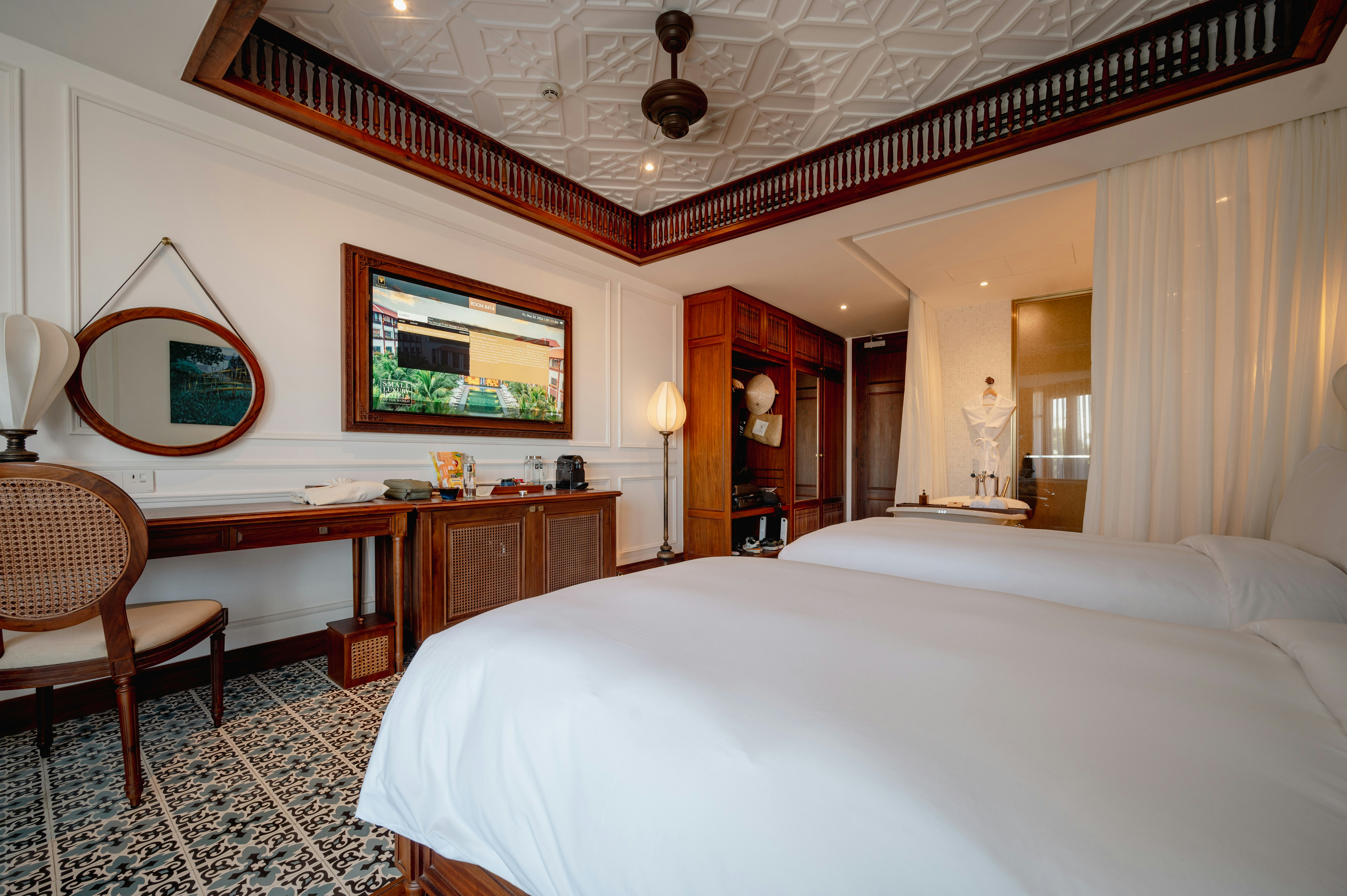 a bedroom with two beds and a desk