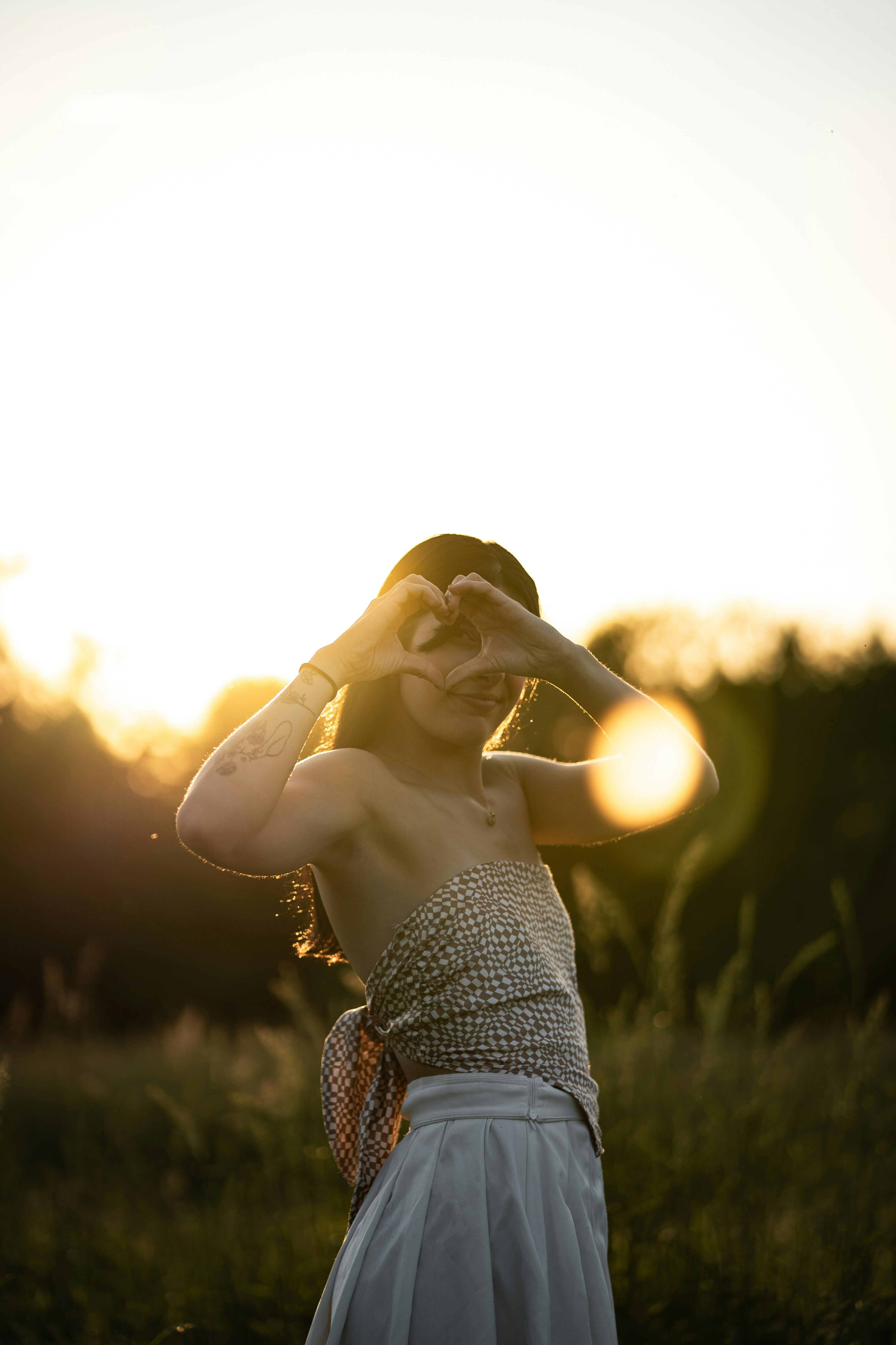 a woman in a dress standing in a field