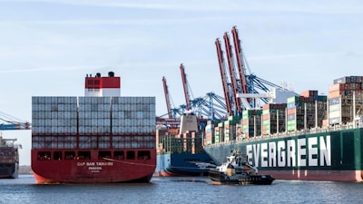 a large cargo ship and a smaller boat in the water