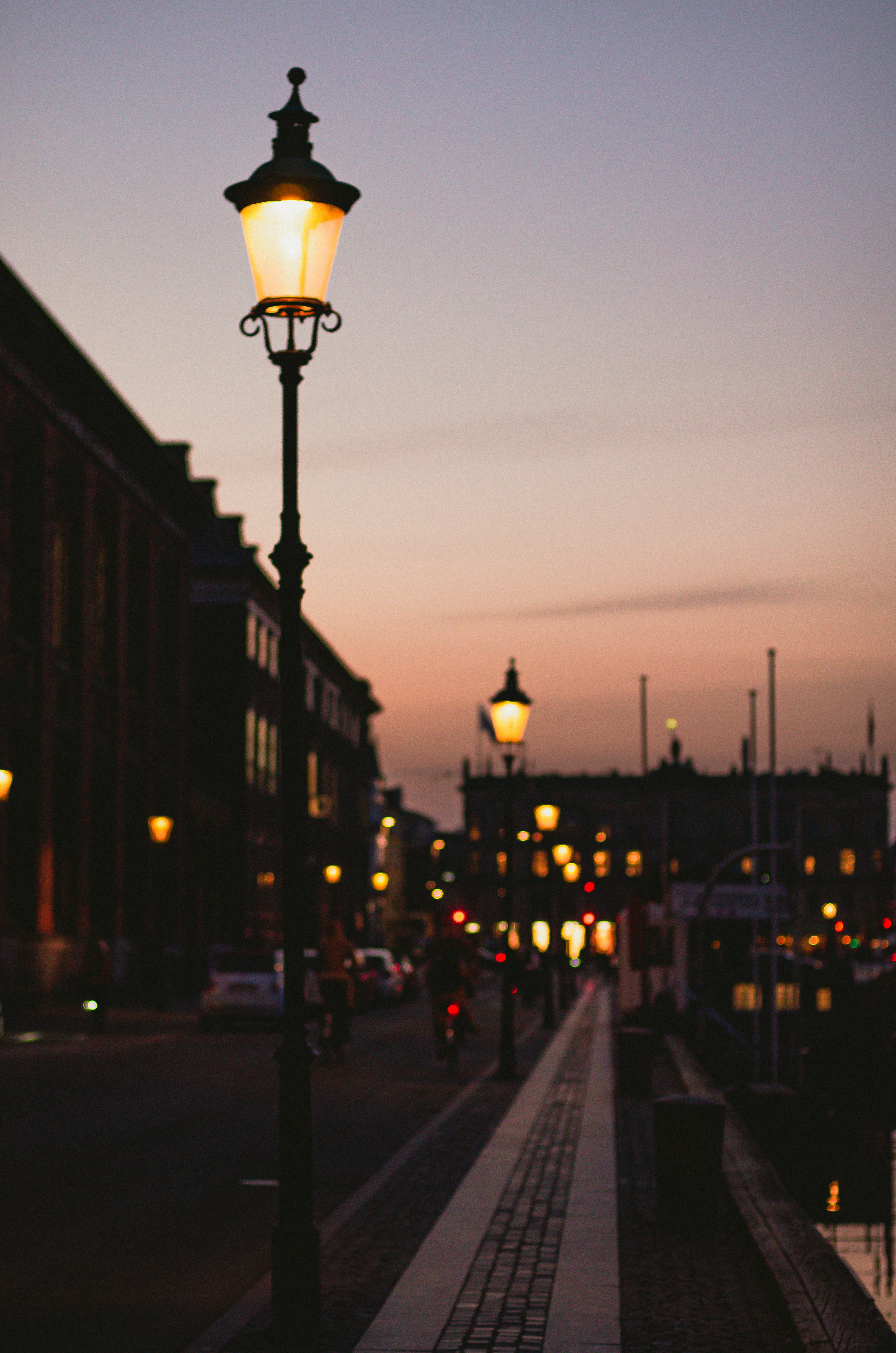 A street light sitting on the side of a road photo – Free Building ...