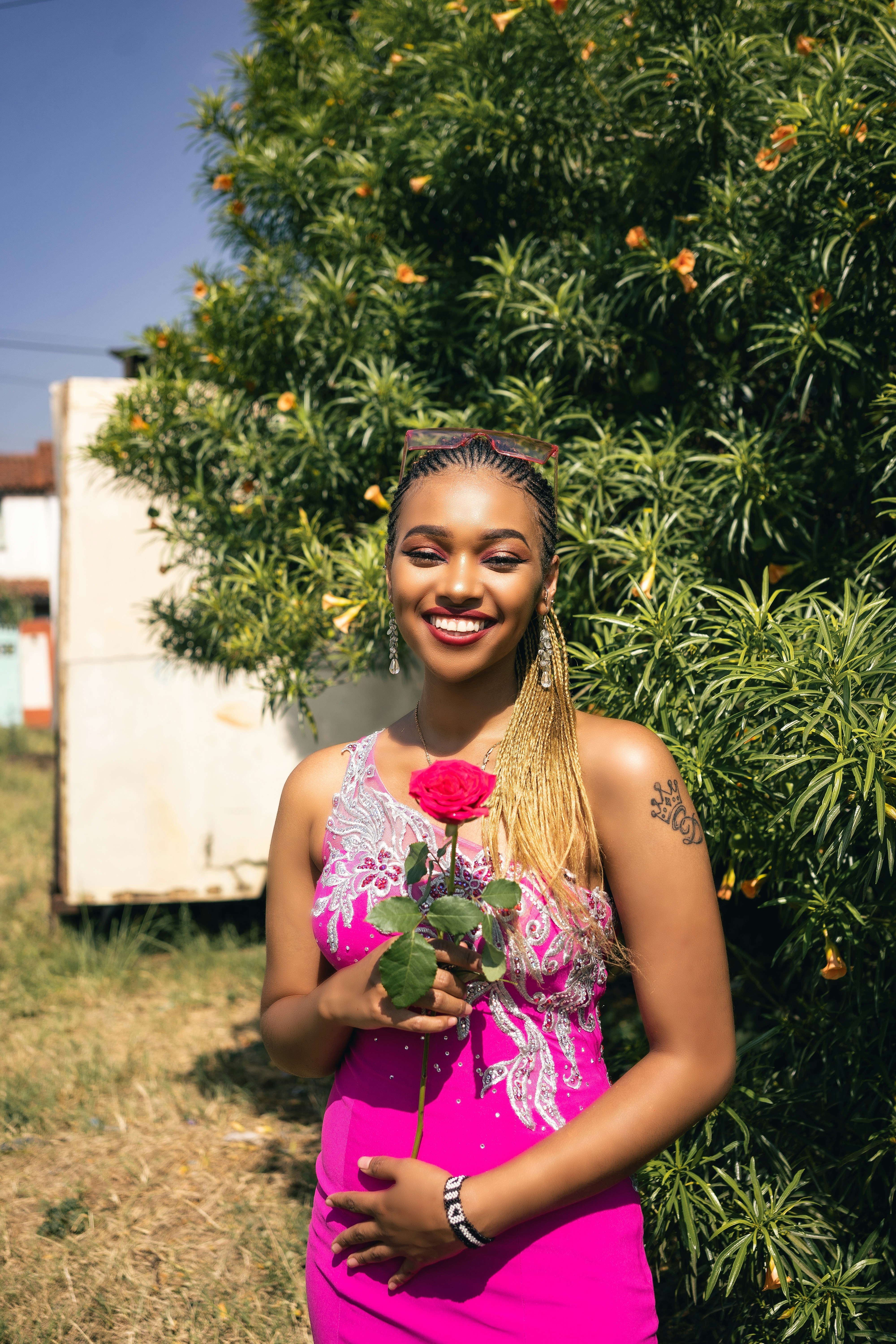 A woman in a pink dress holding a rose photo – Free Woman Image on Unsplash