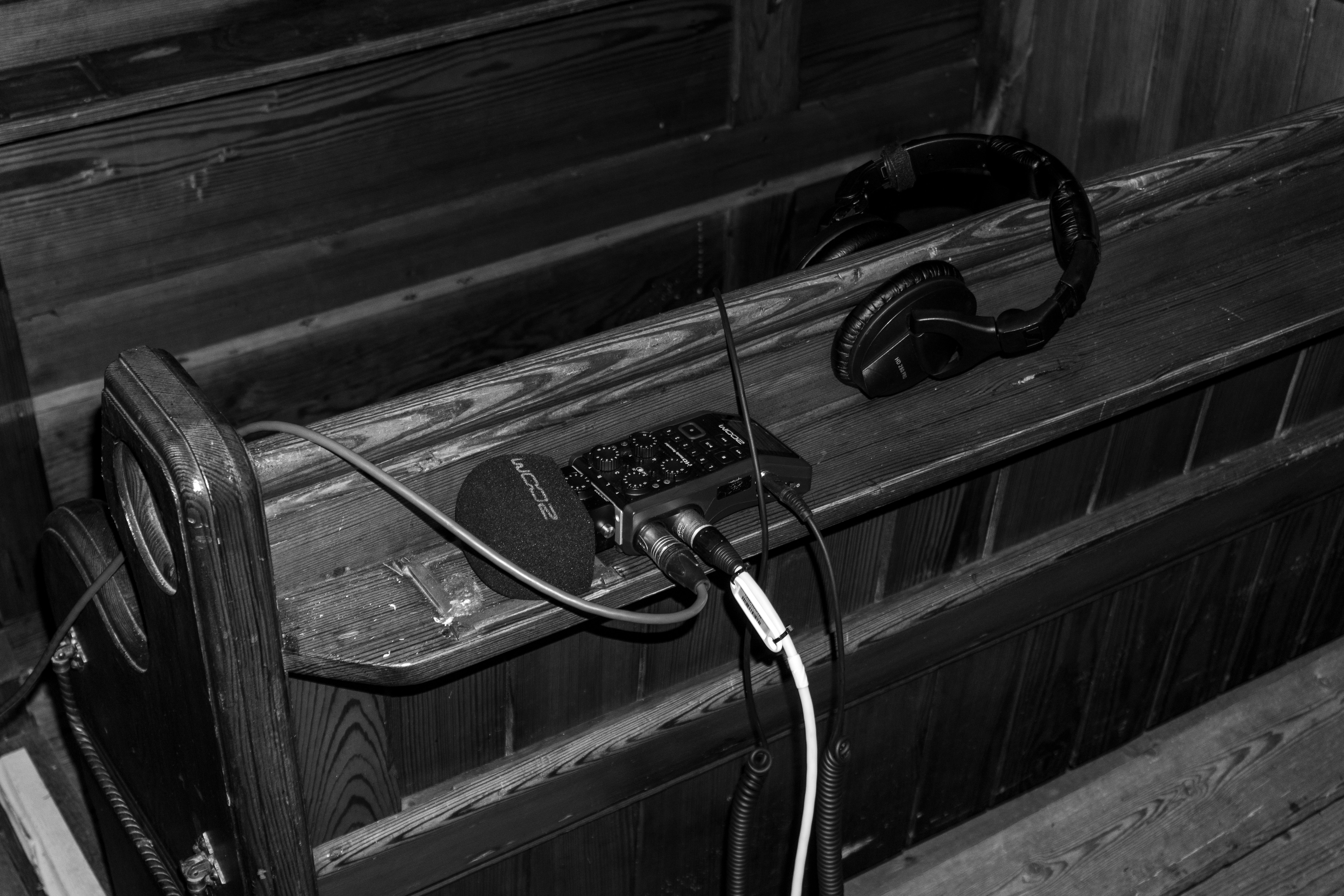 a black and white photo of a bench with headphones on it