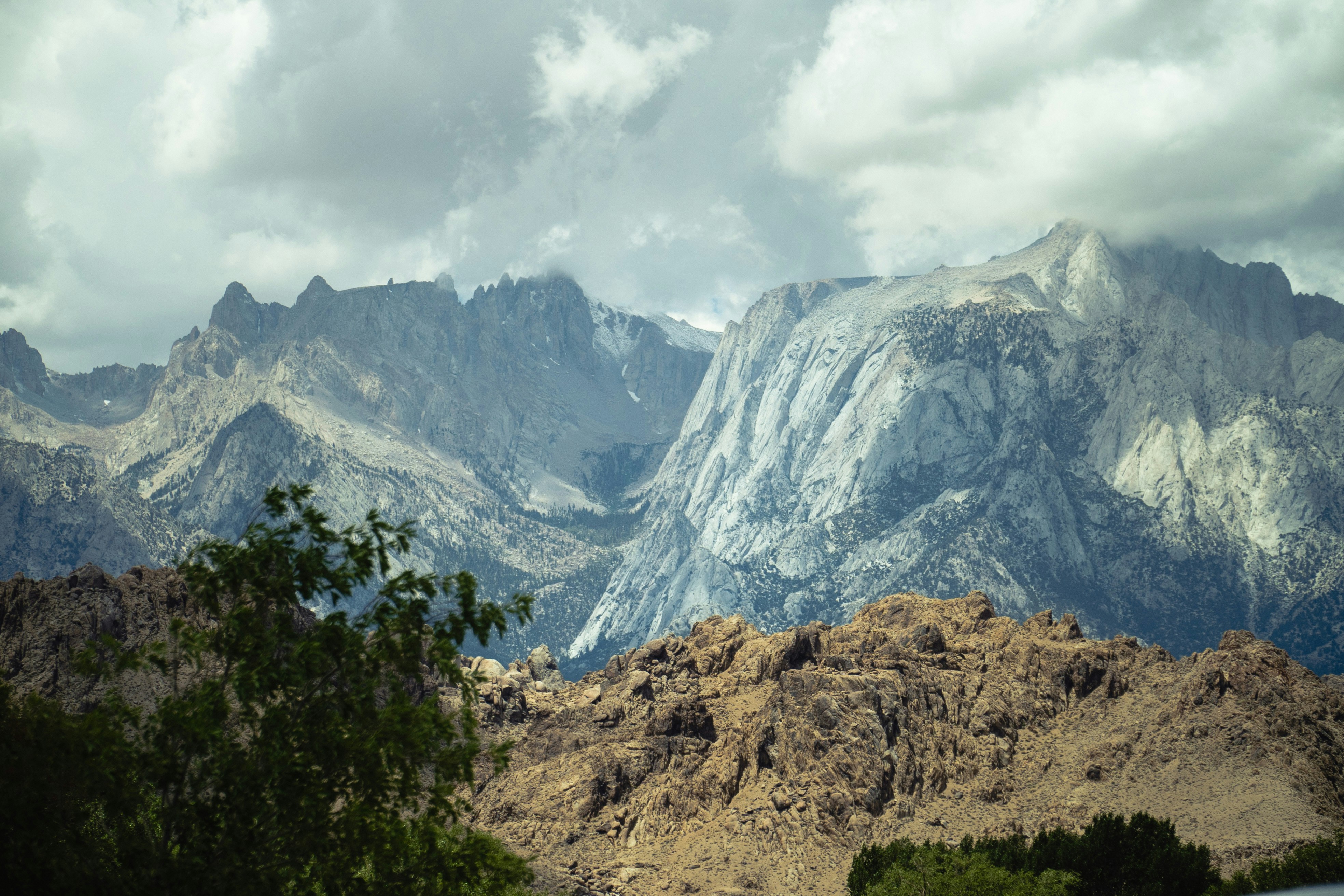 a view of a mountain range with clouds in the sky