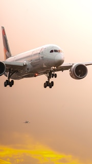 a large jetliner flying through a cloudy sky