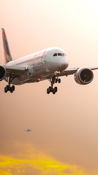 a large jetliner flying through a cloudy sky