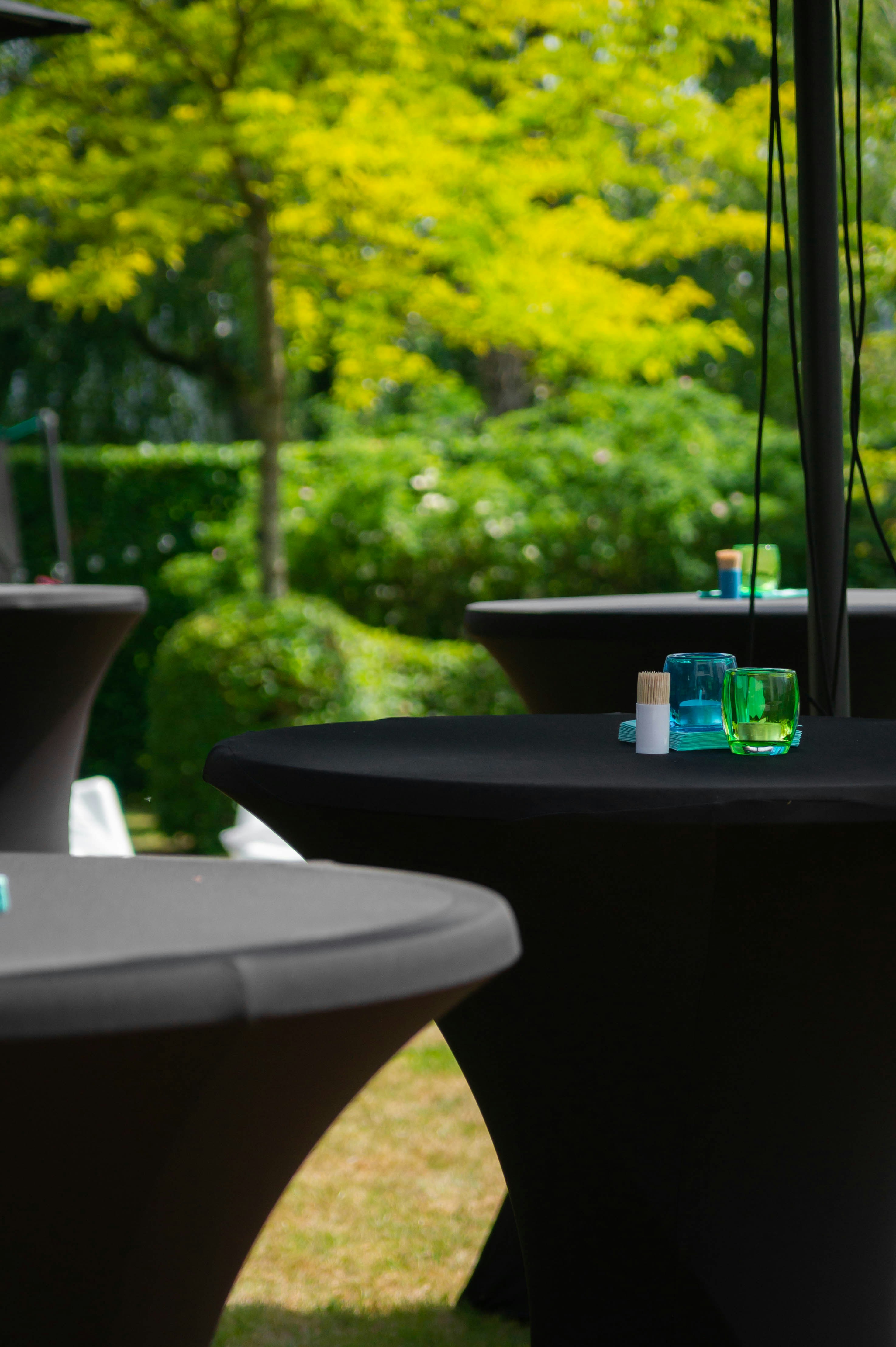 a couple of tables sitting on top of a lush green field