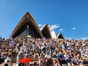 a large group of people sitting in front of a building