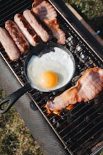 a grill with eggs and sausages on it