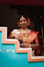 A woman in a sari standing on a set of stairs