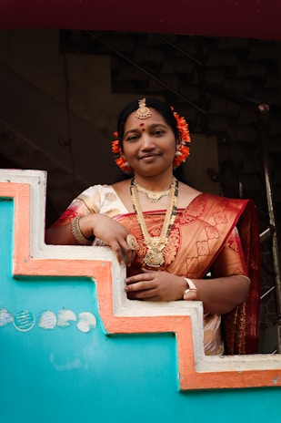 A woman in a sari standing on a set of stairs