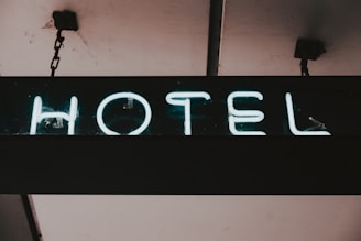 a neon sign hanging from the side of a building