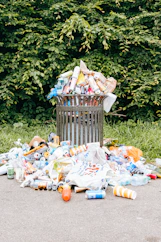 a trash can filled with plastic bottles and other trash