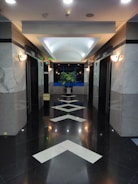 a long hallway with a white arrow painted on the floor