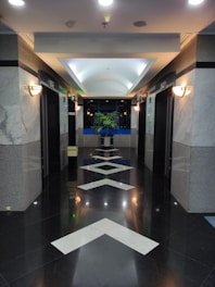 a long hallway with a white arrow painted on the floor