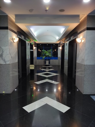 a long hallway with a white arrow painted on the floor