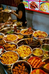 a woman standing in front of a table full of food