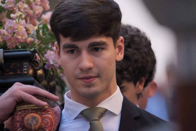 Man in suit holding camera