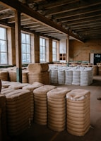 a warehouse filled with stacks of white plates
