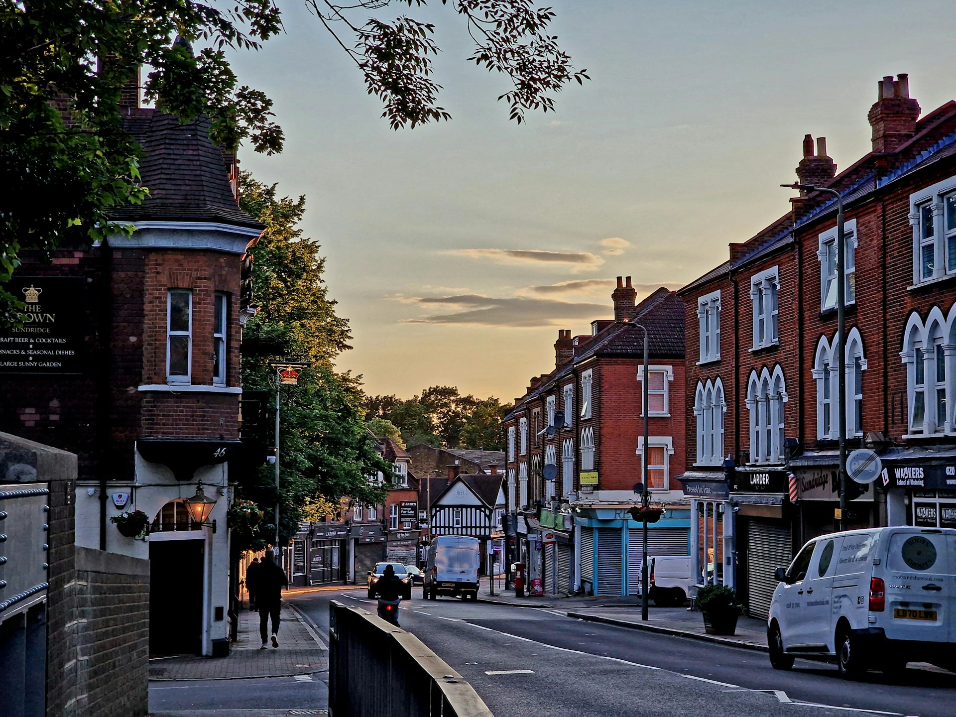 a city street with a few cars parked on the side of the road