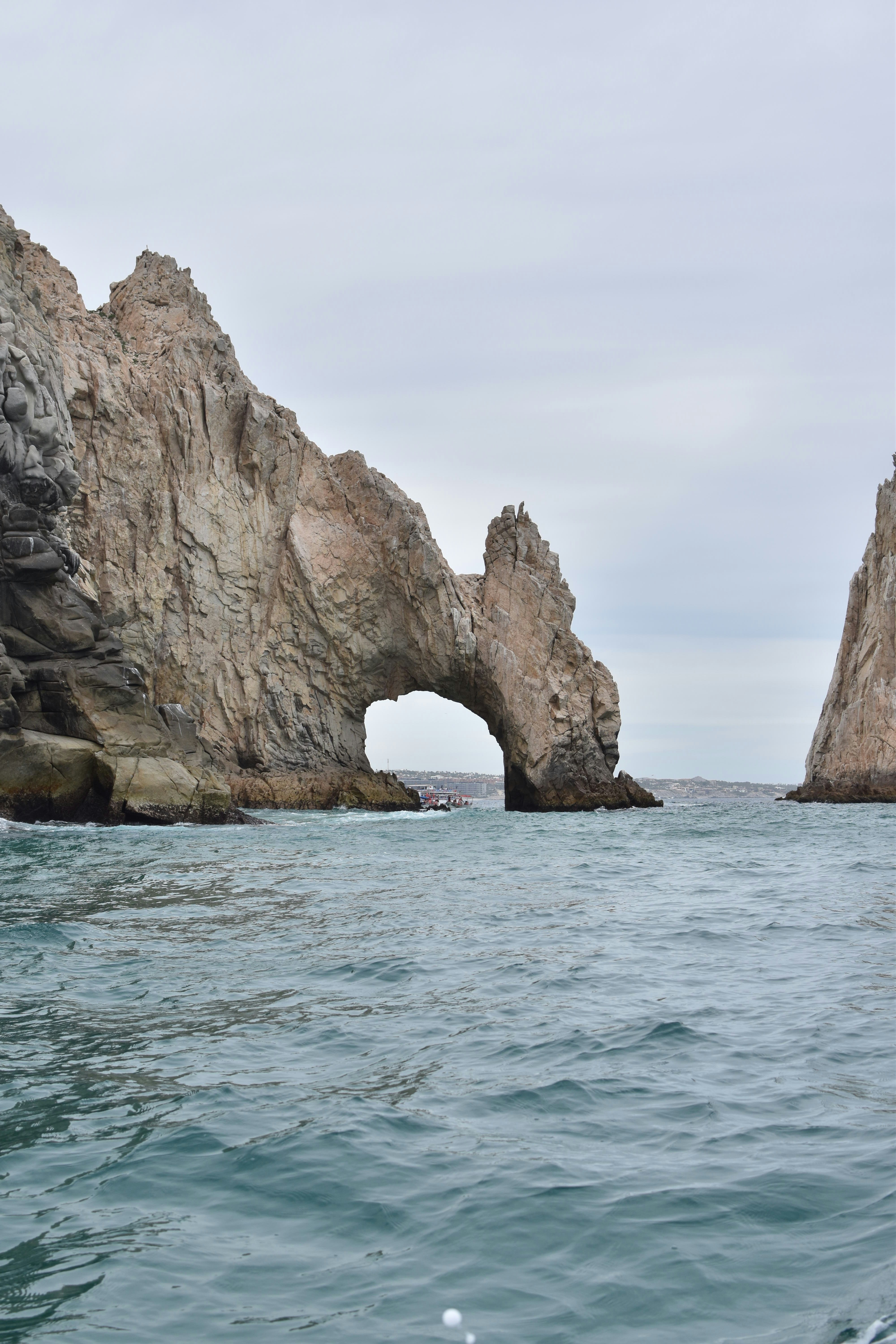 a large rock formation in the middle of the ocean