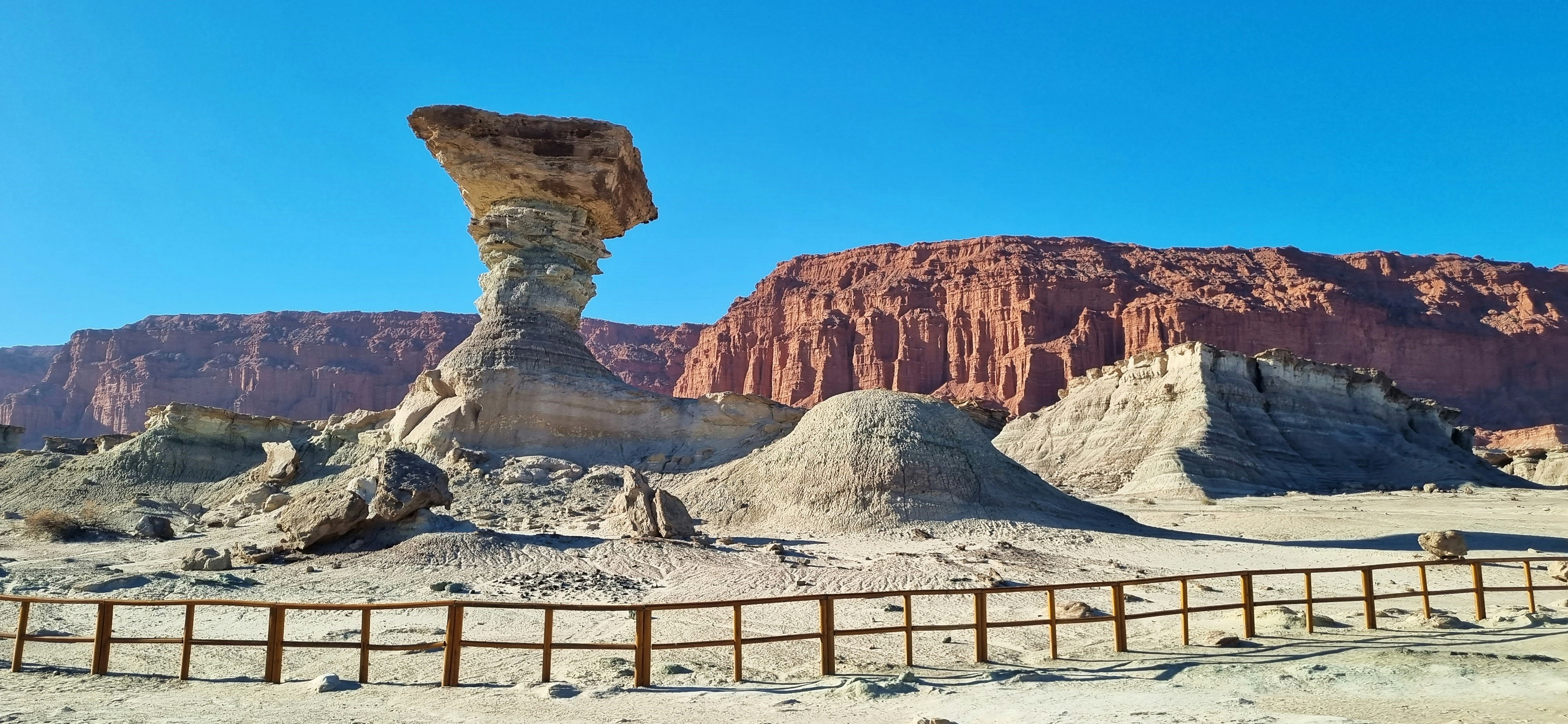 a large rock formation in the middle of a desert