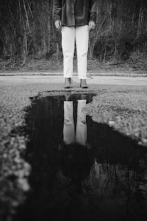 a man standing in the middle of a puddle of water