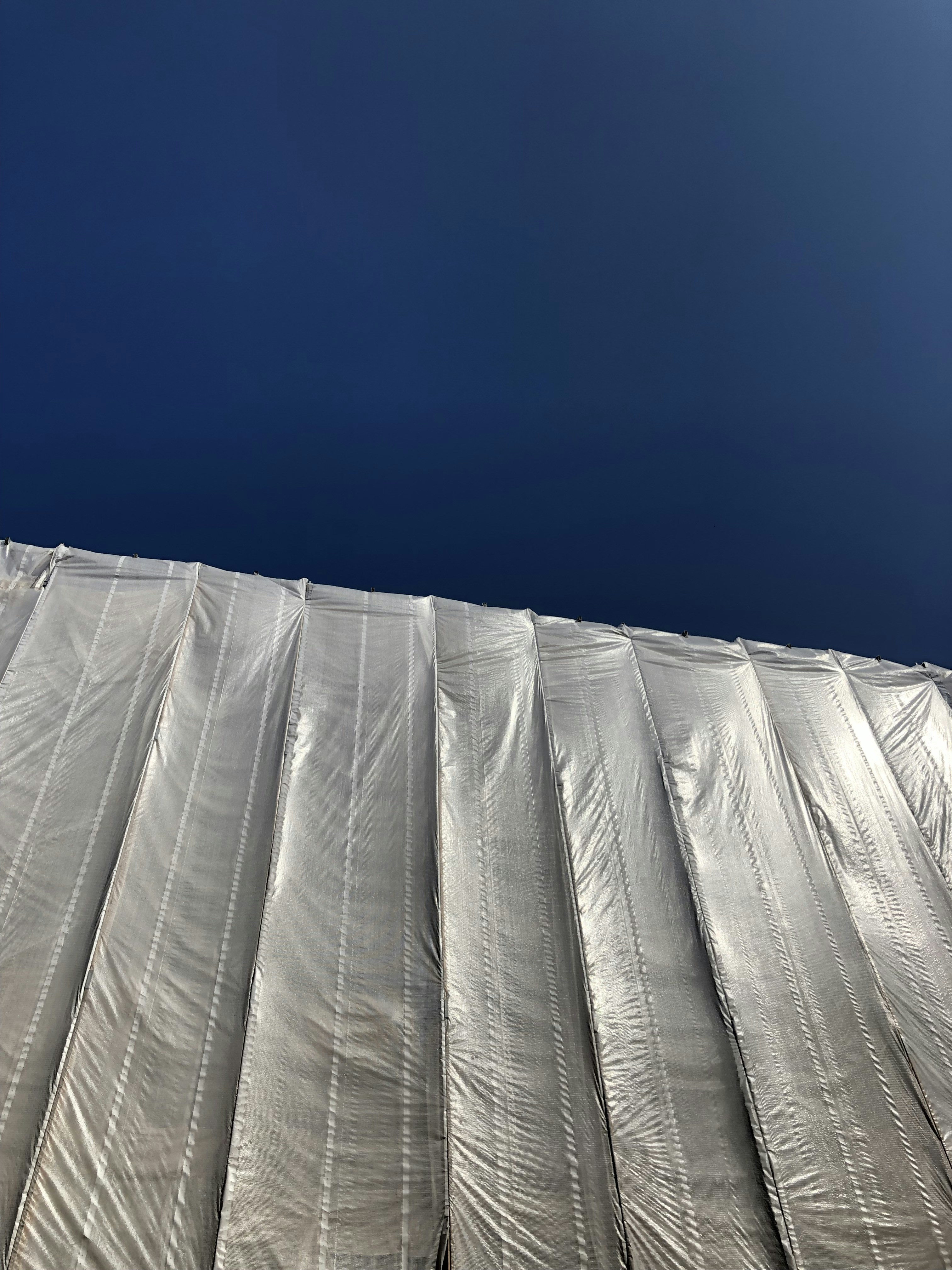 a snowboarder is standing on the side of a building