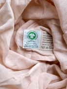 a close up of a label on a pink cloth