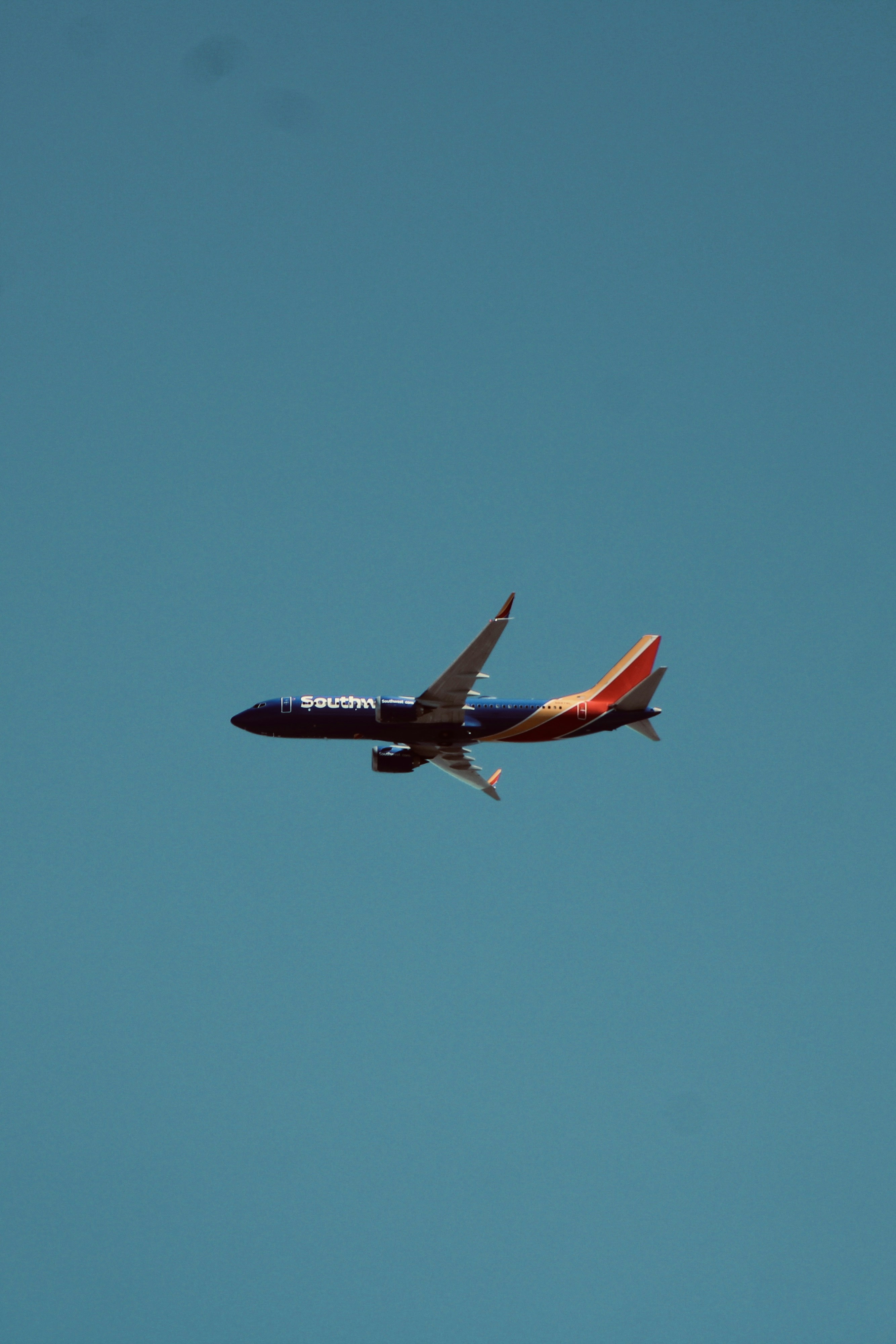 a large jetliner flying through a blue sky