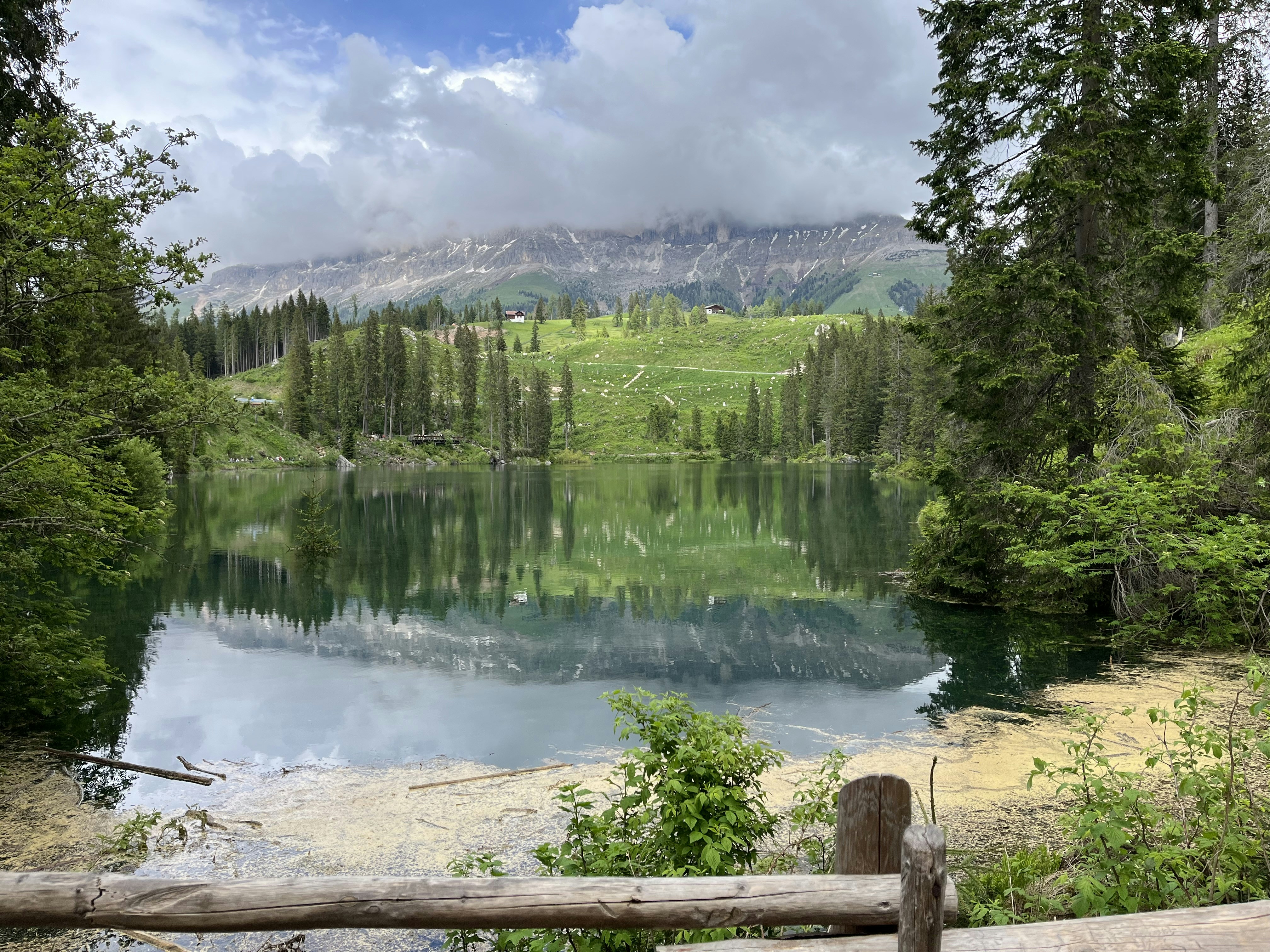 a scenic view of a mountain lake surrounded by trees