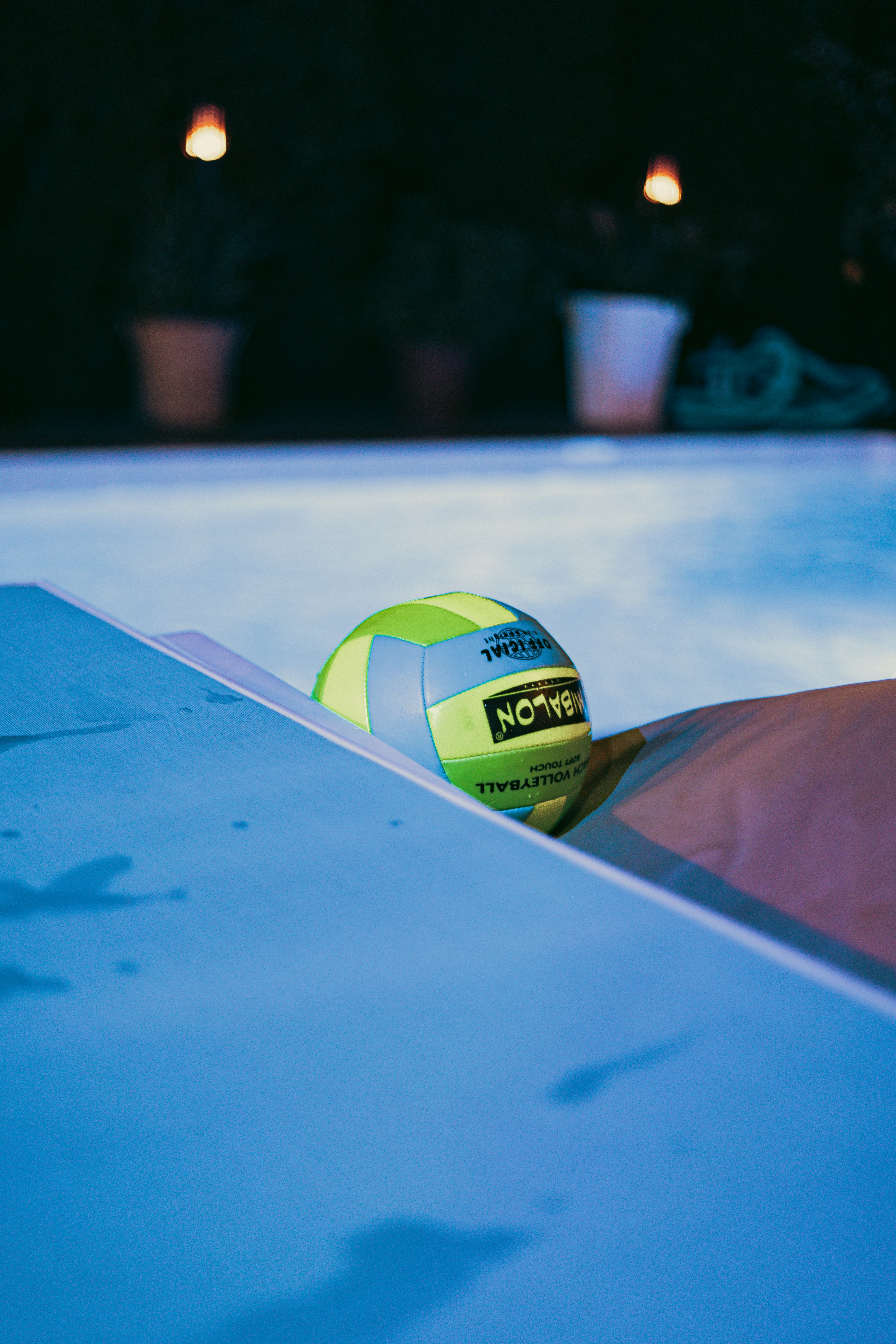 a ball sitting on the edge of a swimming pool