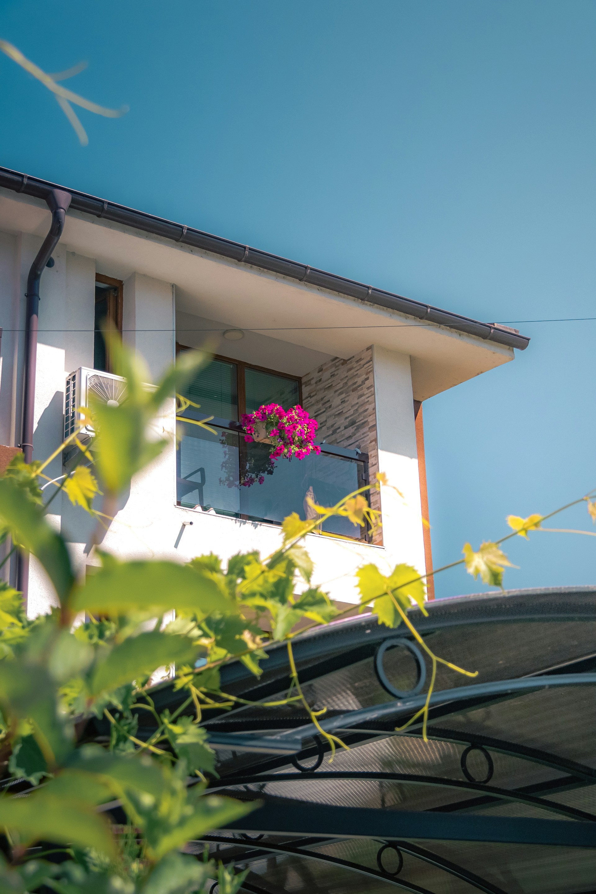a house with a balcony and a flower box in the window