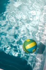 a volley ball sitting in the middle of a pool