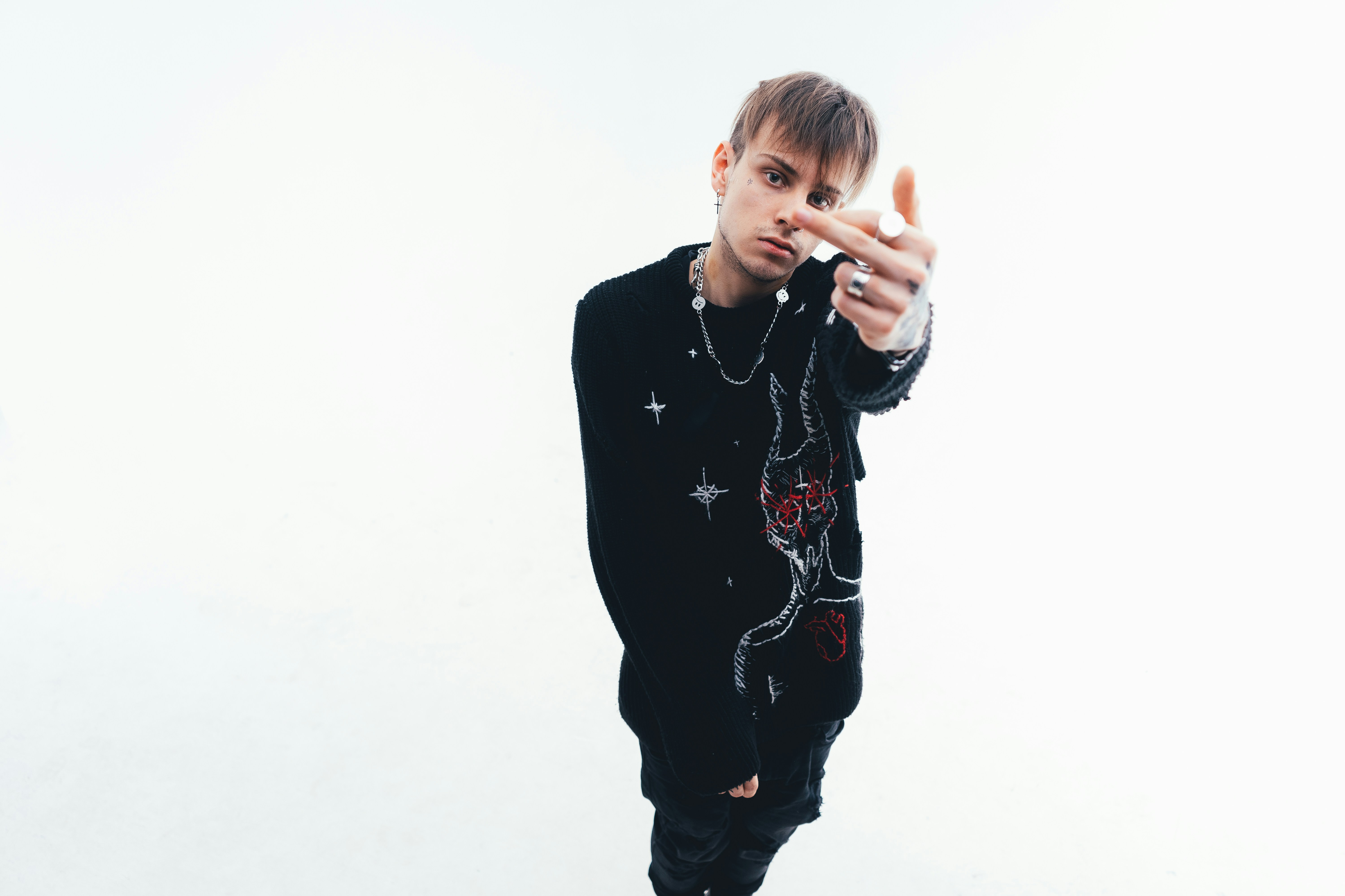 a man in a black shirt making a peace sign