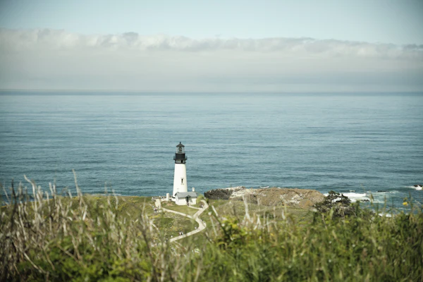 Lighthouse on a New England shoreline hillside