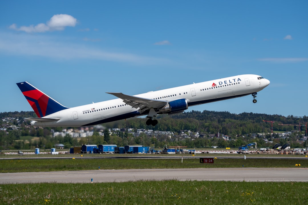 a delta airplane taking off from an airport runway, A Delta Boeing 767 taking off from Zurich Airport.