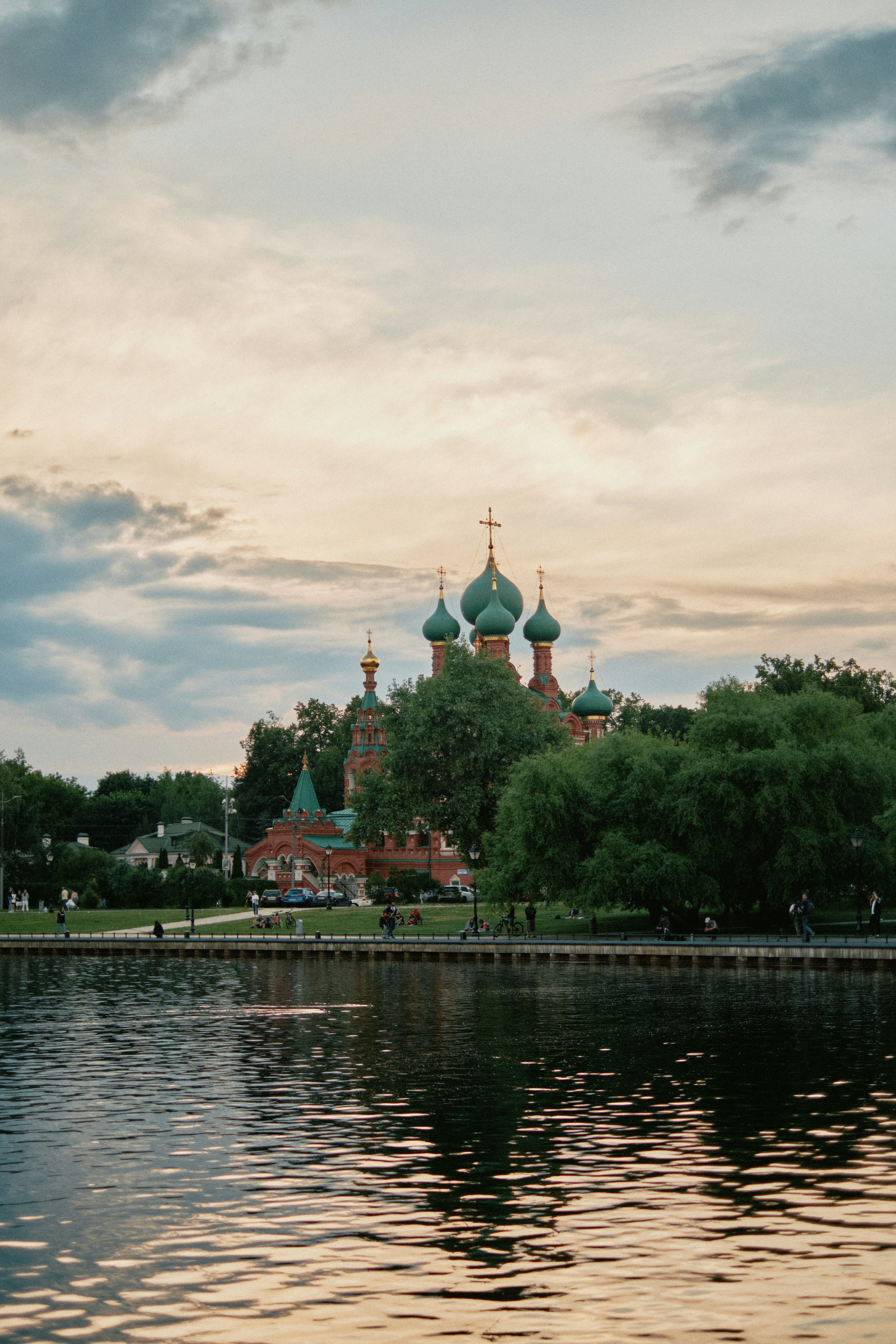 a body of water with a church in the background