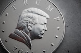 a close up of a silver coin with a picture of president donald