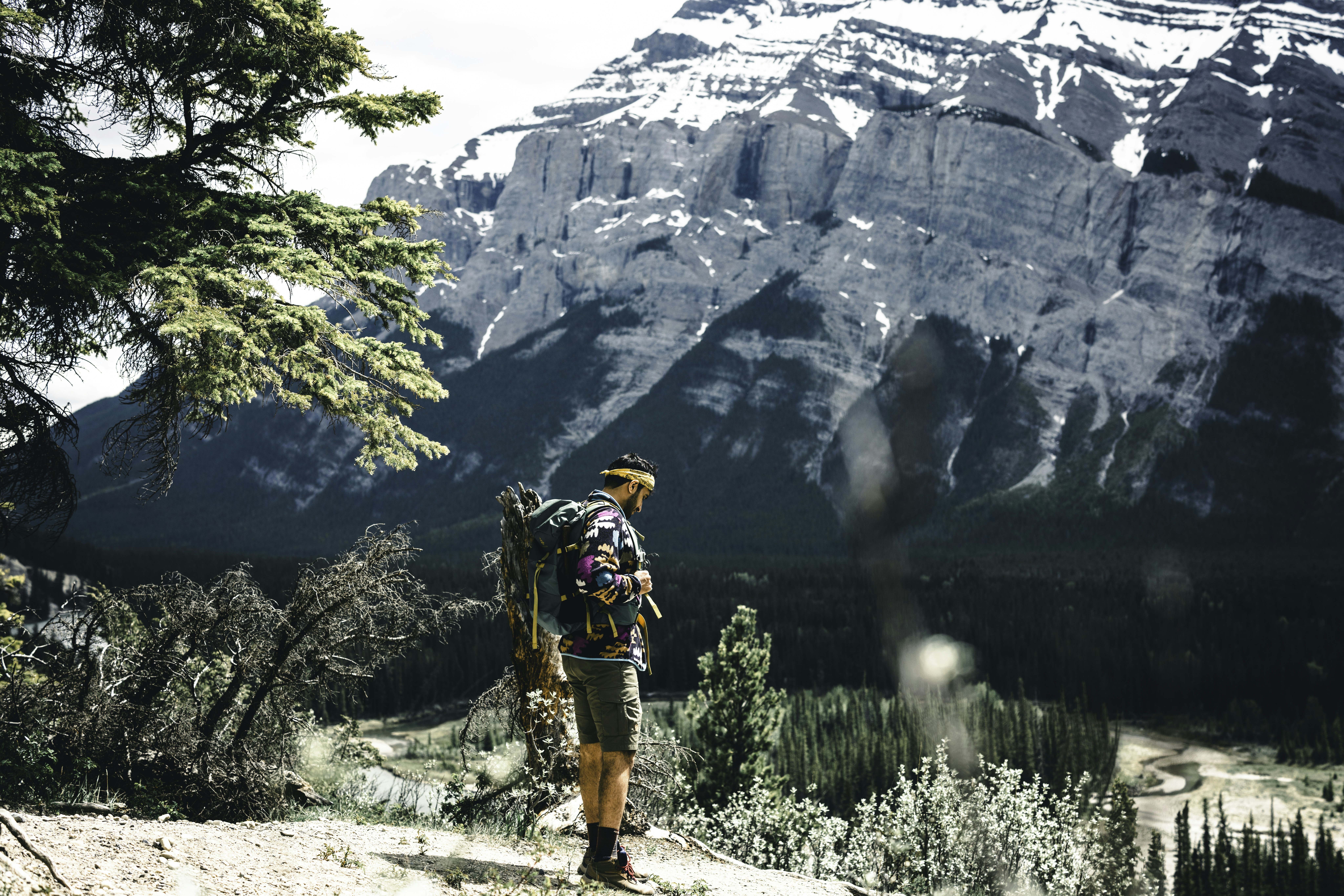 a man hiking in the mountains with a backpack, The hike to hoodoos in Banff National Park