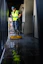 a man in a yellow vest is cleaning the floor